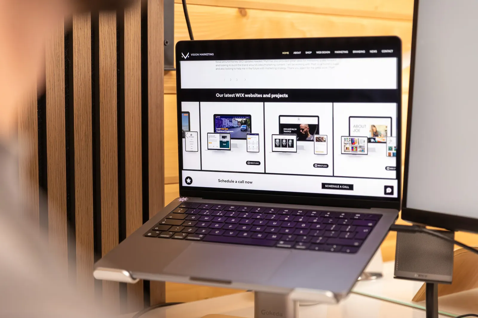 Laptop showing the Vision Marketing website in the studio